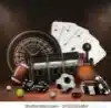 Roulette wheel, playing cards, poker chips, dice, and a bottle on a dark wooden casino table.
